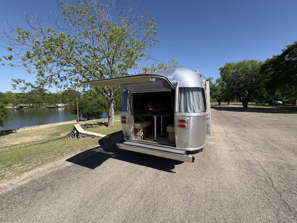 2019 Airstream Tommy Bahama Special Edition 27FB — set up at a lakeside campsite