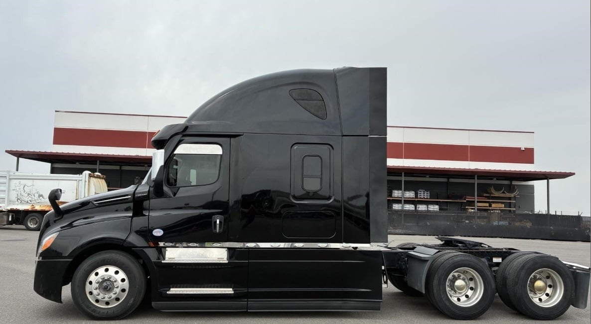 2023 Freightliner Cascadia 126 sleeper semi truck in black — front three-quarter view