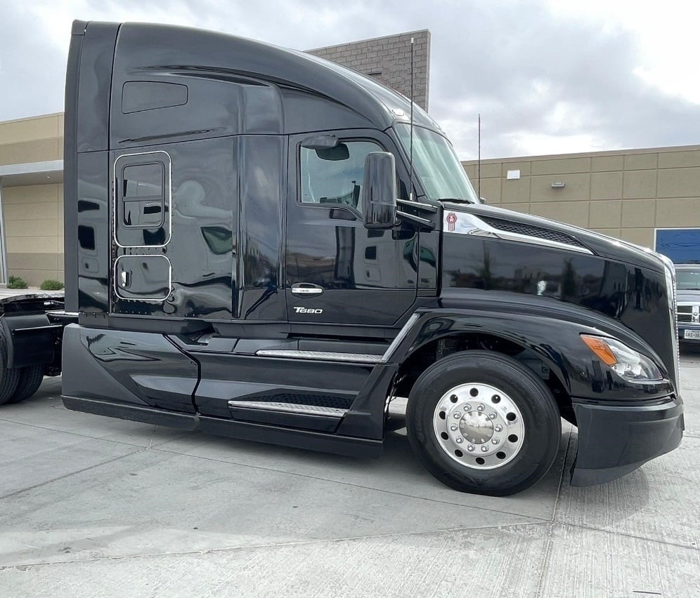 2023 Kenworth T680 sleeper semi truck in black — front three-quarter view