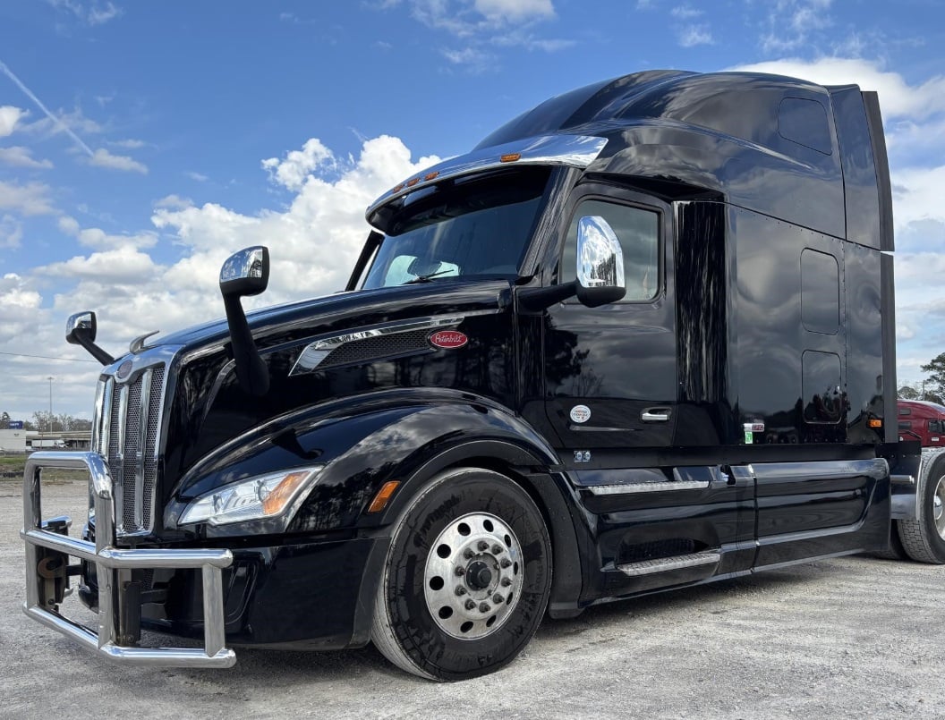 2024 Peterbilt 579 stand-up sleeper in black — front three-quarter view