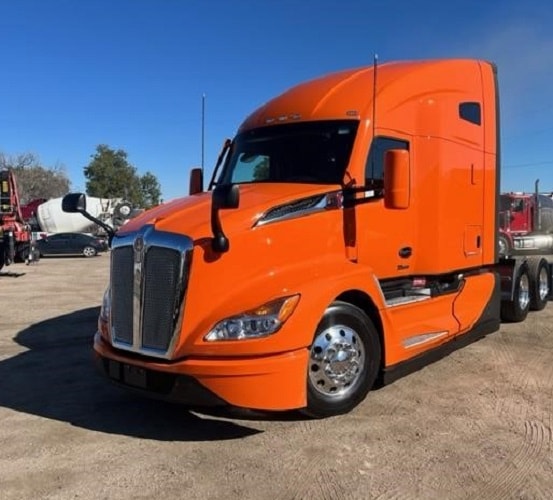 Orange Kenworth semi truck for sale at IronRoute Motors