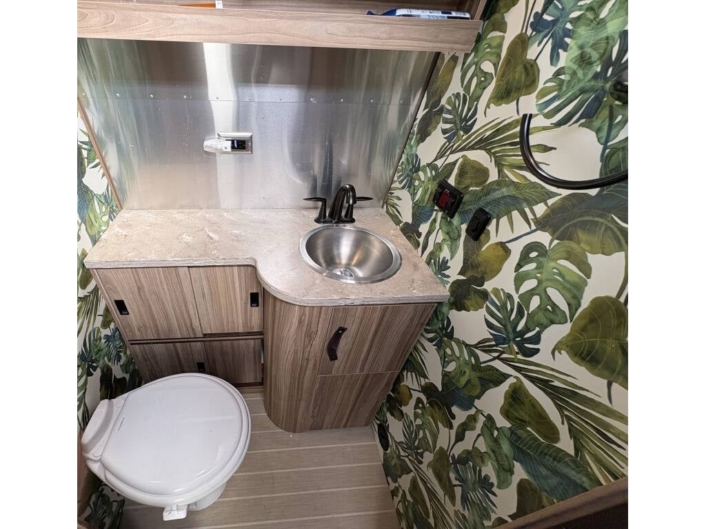 2019 Airstream Tommy Bahama Special Edition 27FB — bathroom with tropical wallpaper