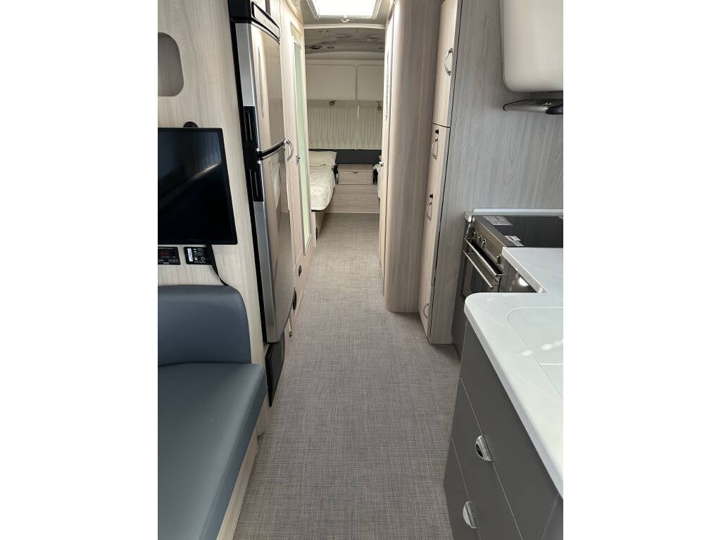 2021 Airstream Globetrotter 27FB Twin — kitchen and bedroom view