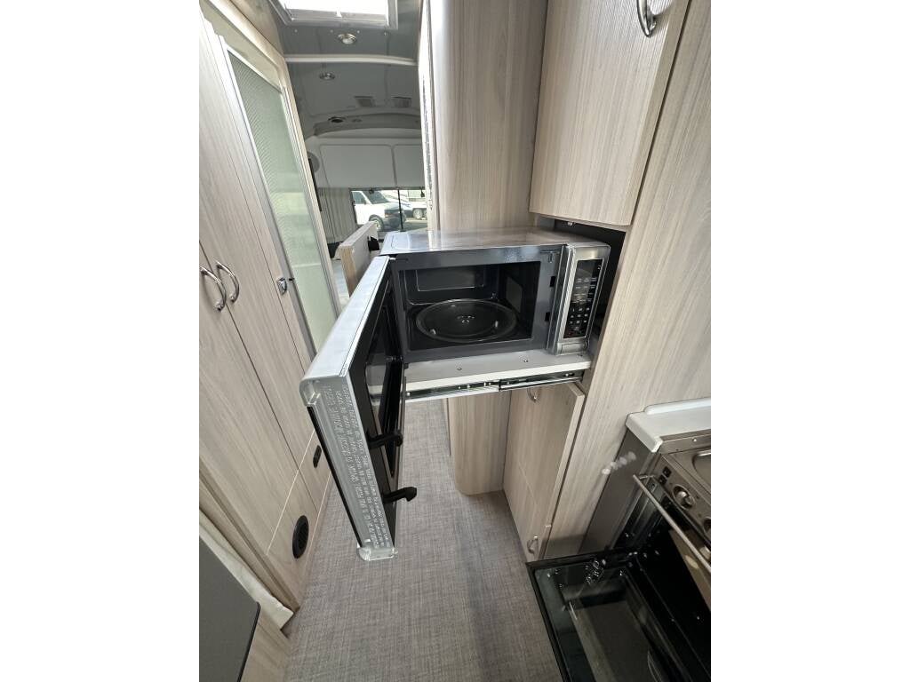 2021 Airstream Globetrotter 27FB Twin — microwave and storage cabinets