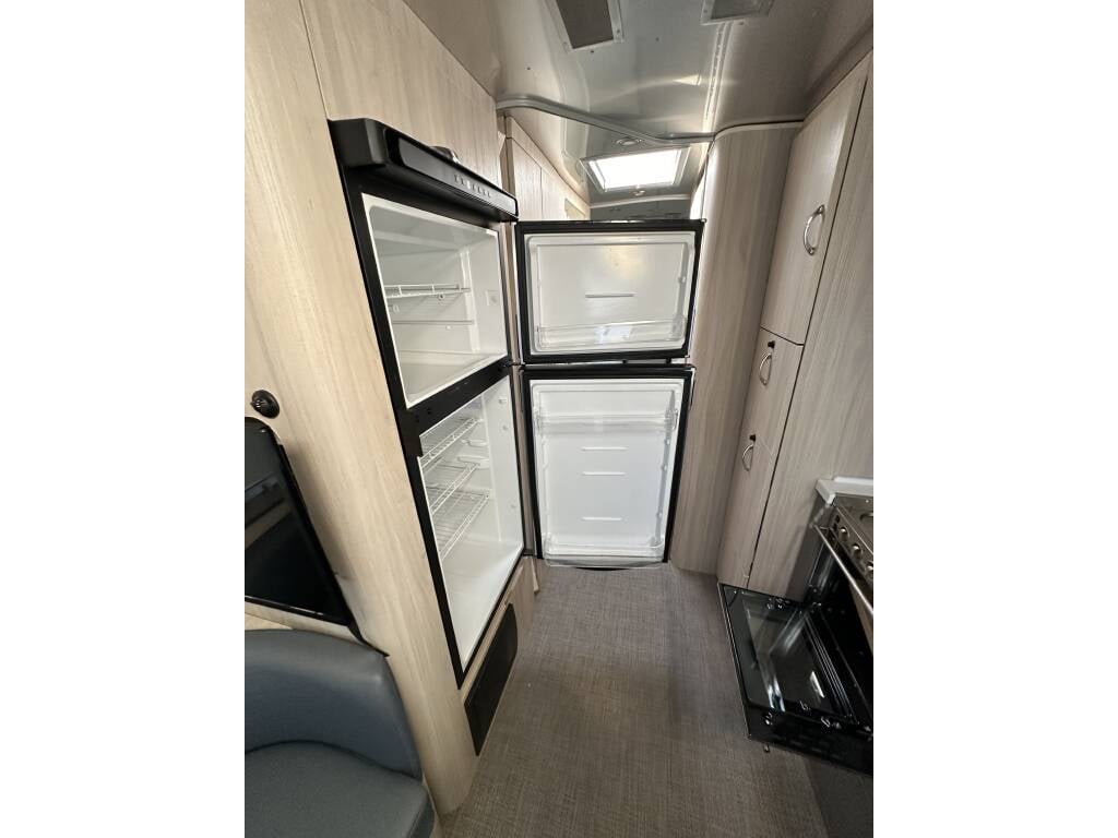 2021 Airstream Globetrotter 27FB Twin — refrigerator in the kitchen