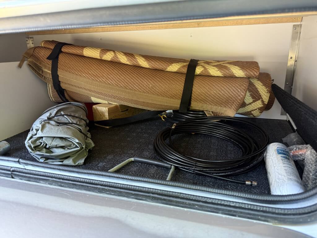 2022 Airstream Flying Cloud 27FBQ — exterior storage compartment with camping gear