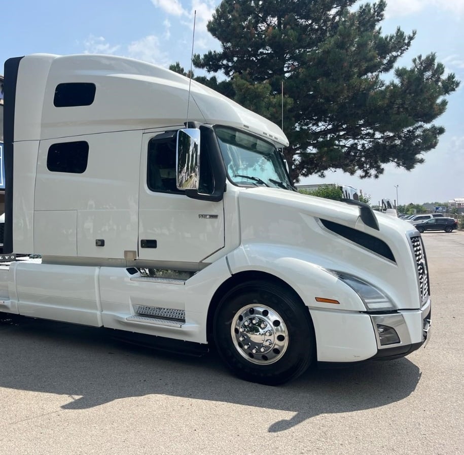 2023 Volvo VNL64T760 sleeper semi truck in white — front three-quarter view